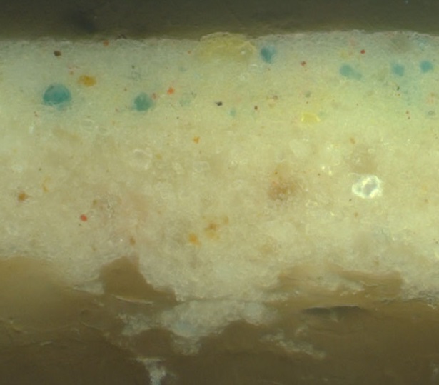 Cross-section of a sample from the sky in the painting The greenish-blue specks in the uppermost paint layer are particles of cerulean blue