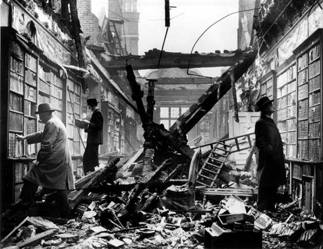 An interior view of the bombed library at Holland House with readers apparently choosing books regardless of the damage. Fox Photos, a London photographic agency.