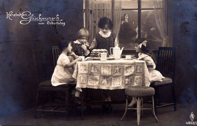 Girls_with_birthday_cake._Postcard_from_1920